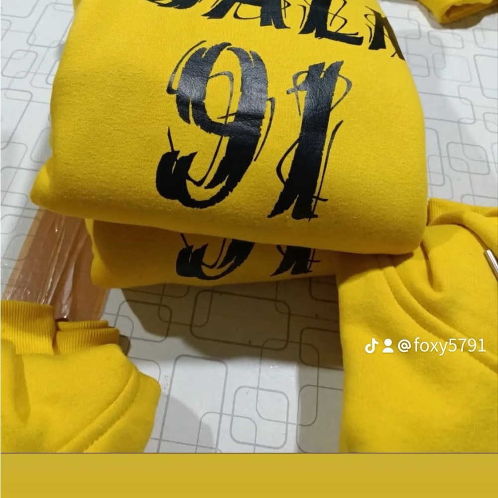 Hooded sweat shirt, in yellow, size small to large.